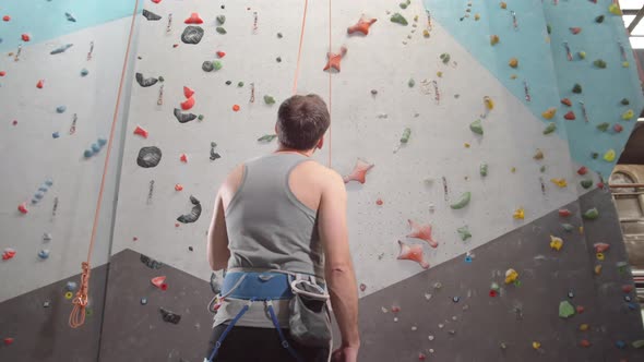 Middle-aged Sportsman Getting Ready for Climbing alt