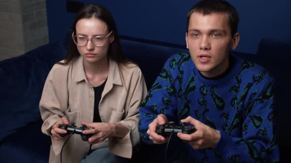 Young People Playing Video Games Console While Sitting Couch Front Tv alt
