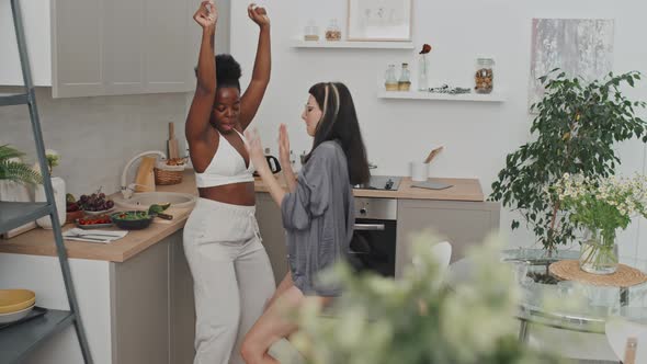 Lesbian Couple Dancing in Kitchen in Morning alt