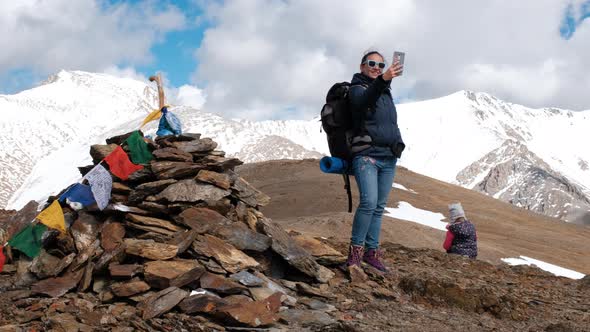 Young Woman Hiker Taking Selfie in Mountains alt