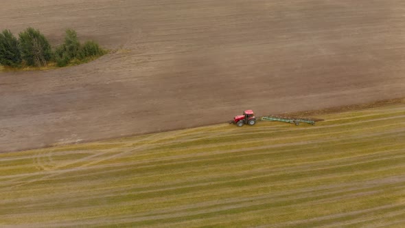 Aerial Wheel Tractor Plowing the Stubble Cover a Wide Swath