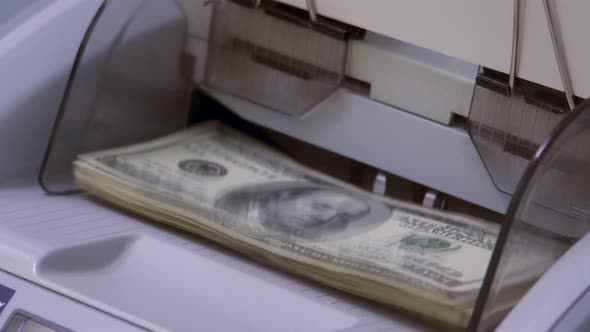 Close Up Currency Counting Machine Counting American 100 Dollar Bills. Banknote Counter Are Counting
