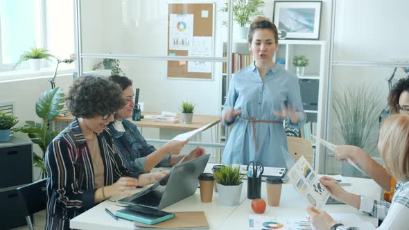 Joyful Asian Woman Talking To Group of Office Workers and Doing Highfive Enjoying Success in alt