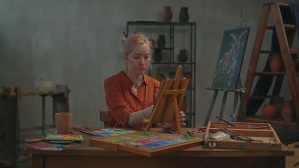 Inspired Female Artist Painting Canvas on Small Easel alt