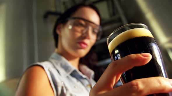 Close-up of female brewer testing beer alt
