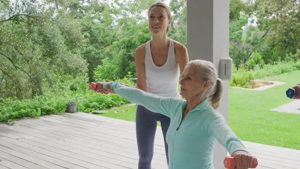 Senior woman exercising in a garden alt