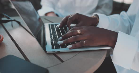 Woman sits and works on laptop alt