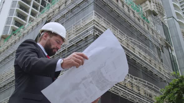 An Engineer a Developer at a Construction Site Checks the Drawings at What Stage of the Construction alt