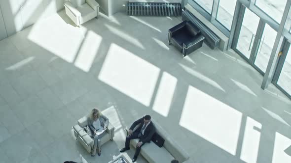 Businesspeople Discussing Work in Lobby alt