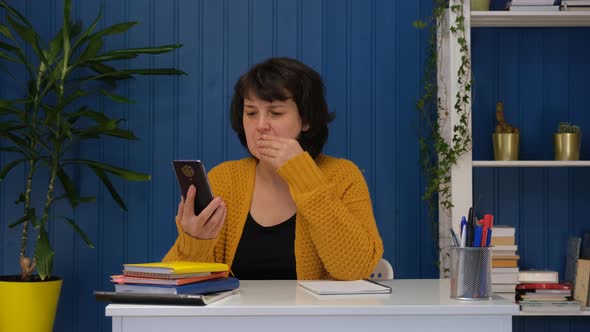 Middle Aged Woman Reading Online Bad News and Shocked