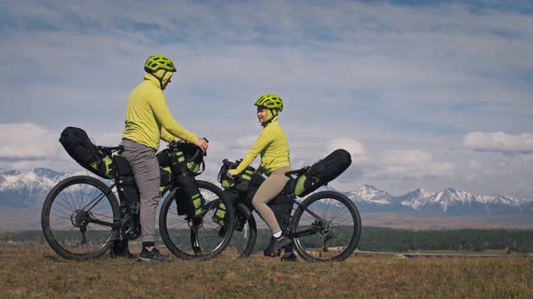 The Man and Woman Travel on Mixed Terrain Cycle Touring with Bikepacking alt