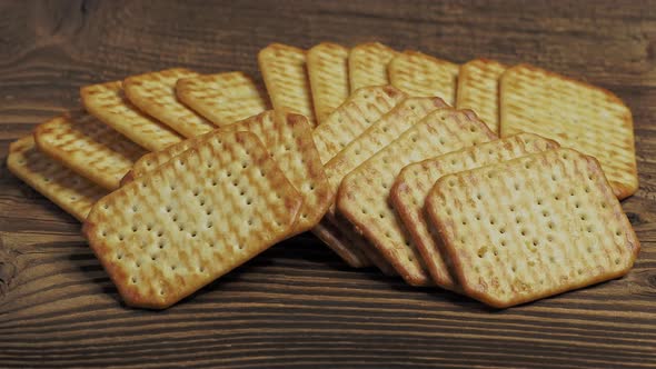 Dry salty cracker cookies isolated on wooden background 