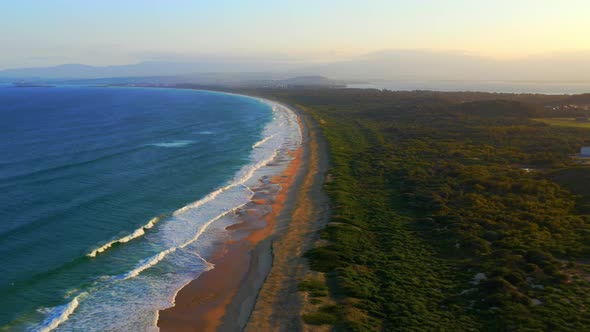 Fast-moving Aerial view of Scenic Wild Natural Beach - Port Kembla near Wollongong, NSW Australia alt