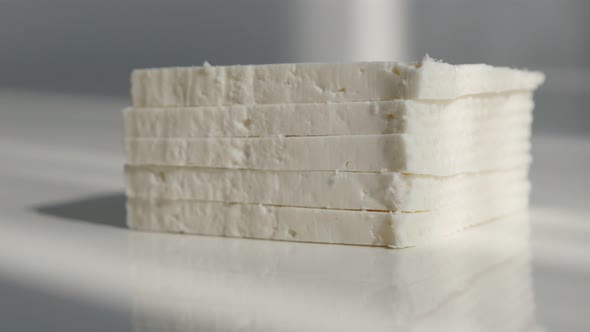 Stacked pieces of cow milk cheese 4K tilting video alt