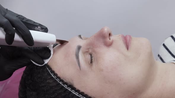 Young woman receiving ultrasound cavitation facial peeling cleansing alt