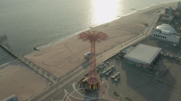 Aerial Shot Tilting Down as Drone Flies Over Coney Island's Parachute Tower alt