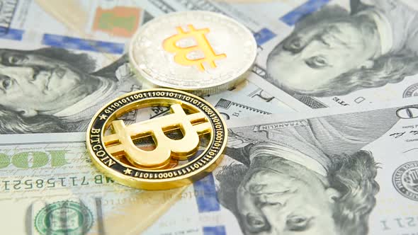 Gold Coin Bitcoin Close  Up on the Background of Hundred Dollar Bills alt