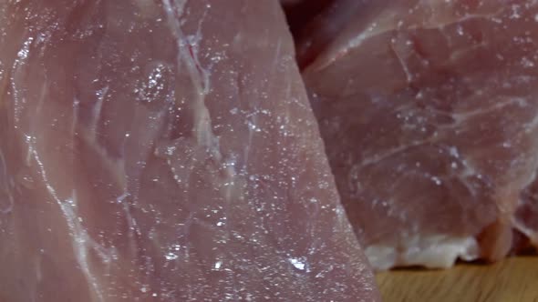 Raw pork meat on  spinning table alt