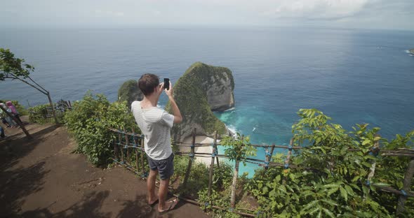 Back View of a Male Tourist Taking Pictures of the Beautiful Tropical TRex Bay Peninsula at alt