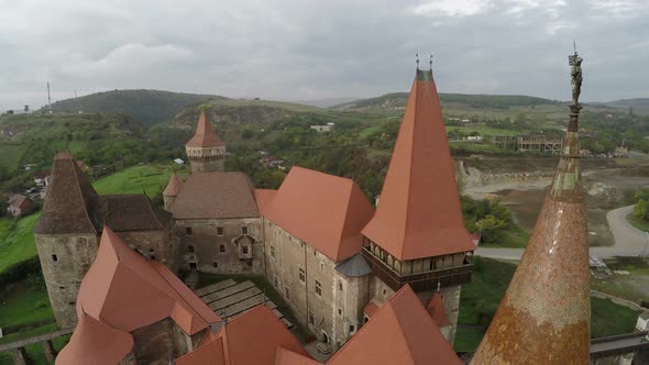 Aerial view of Corvin Castles rooftops and towers alt