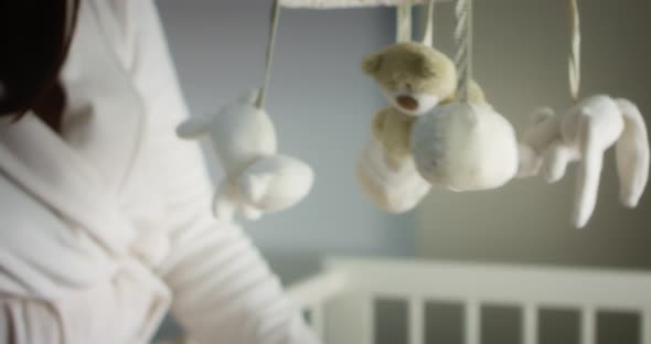 Baby Mobile with Different Animals Hanging Over the Child Crib of a Newborn