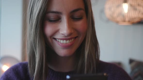 Beautiful Woman Smiling As She Texts