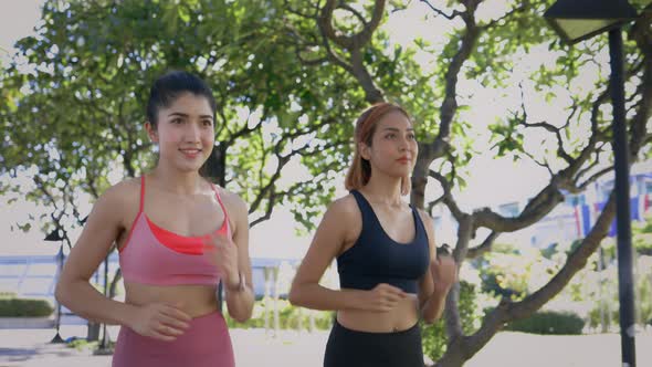 Female Friends Running in Park alt