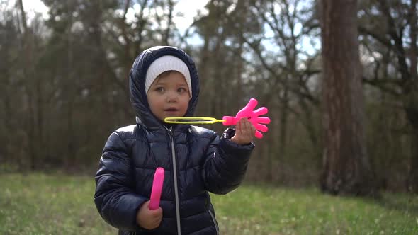 Young Girl Blowing Bubbles in the Forest, Slow-mo