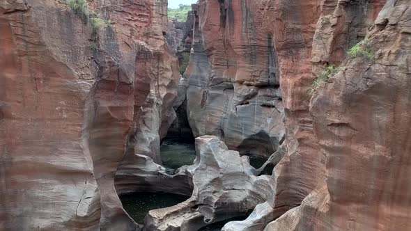 HD aerial drone footage of Bourke's Luck Potholes. Beautiful natural rock formations hewn by centuri alt