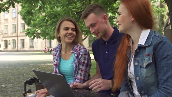 Students Work on Laptop on Campus alt