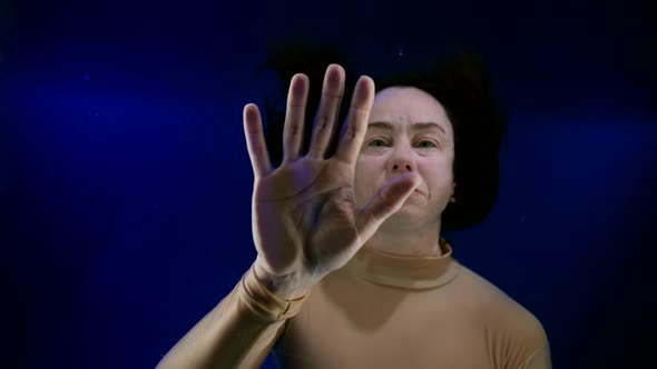 Diving in Depth of Large Aquarium with Blue Water Portarit of Woman Underwater alt