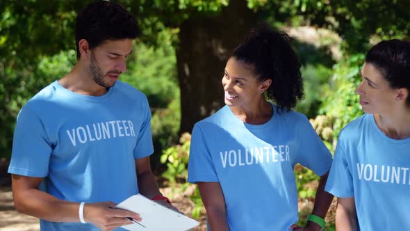 Volunteers discussing with each other in park 4k alt