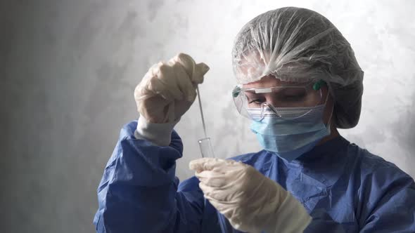 PCR test in the laboratory. The doctor looks at the sample taken to collect smears for COVID-19. alt