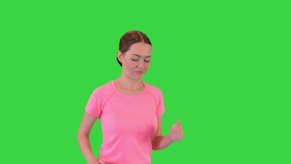 Woman in a Pink Tshirt Running on a Green Screen Chroma Key