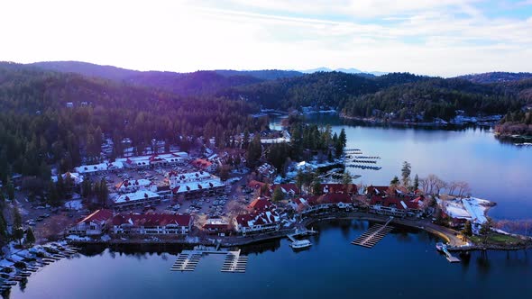 Flying over Lake Arrowhead Village with light snow. alt
