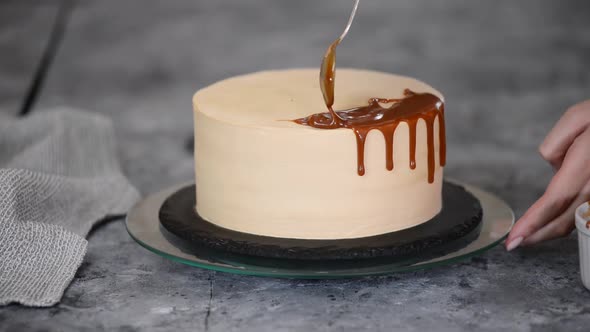 Pastry Chef Decorate the Cake with Caramel Sauce