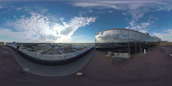 360 VR Man in Rooftop Cafe Looking at Airport and Road Traffic, Moscow alt