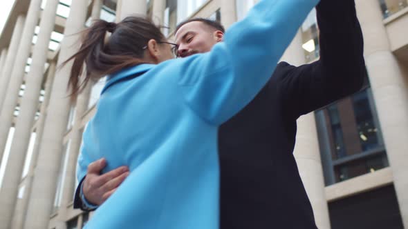 Low Angle View of Young Stylish Couple Dancing Outdoors alt