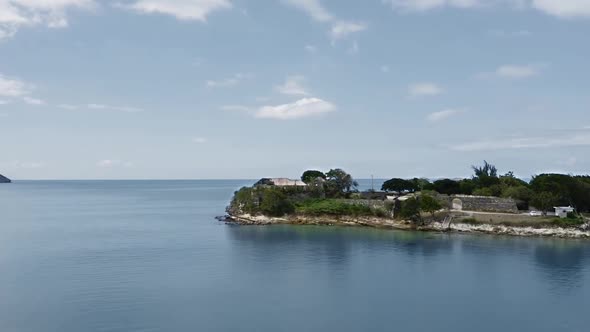 Air camera approaches the sea coast with Fort James ruins in St. John's, Antigua and Barbuda alt