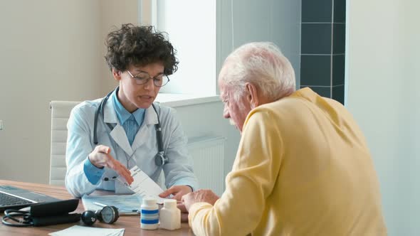 Female doctor consulting old man