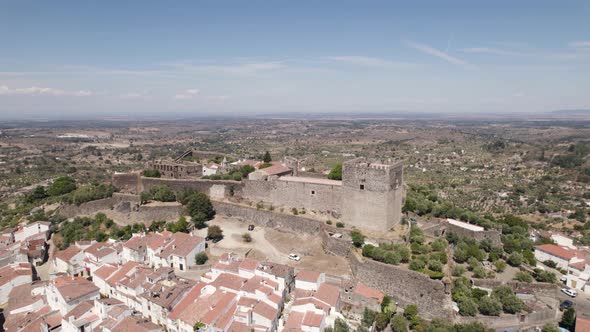 Castelo de Vide perched castle and surrounding landscape, Portugal. Aerial orbiting alt