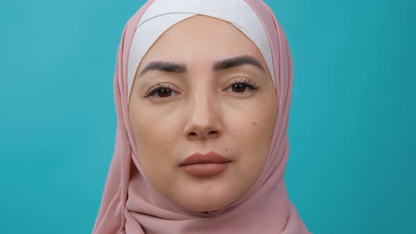 Extreme Close Up Portrait of Young Middle Eastern Muslim Woman in Hijab Looking Serious at Camera
