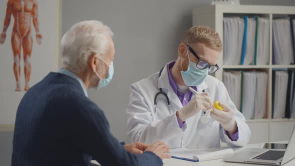 Doctor Prescribing Medicine To Patient Wearing Masks alt