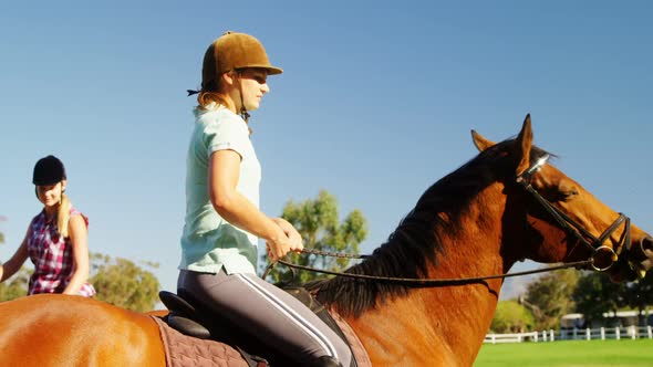 Friends riding horse in ranch 4k alt