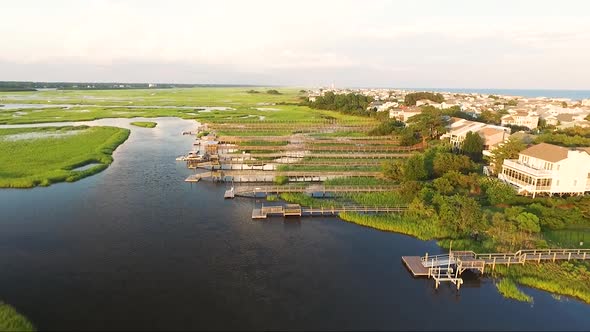 Ocean Isle Beach at sunset near the causeway and ocean flying over houses and piers alt