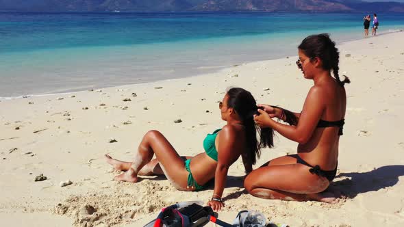 Tourists posing on marine island beach journey by transparent water and white sand background of Gil alt