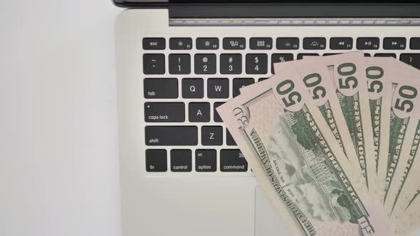 Top View of Dollars on Keyboard of Laptop, Business Concept alt