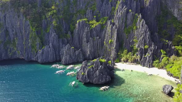 Aerial View of Secret Lagoon with Karst Cliffs and White Beach. El-Nido, Philippines alt