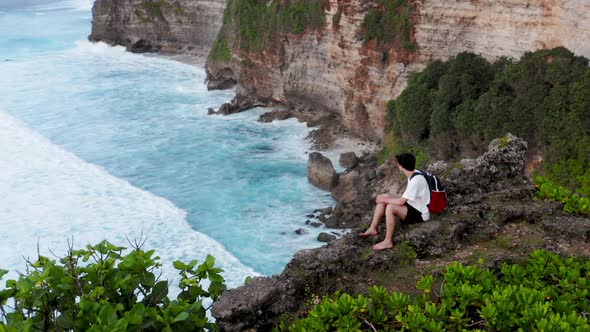Guy Sits on Edge of Cliff, Young Boy Coming To Edge of Cliff and Sitting Down, Man Sitting  alt
