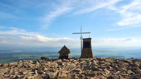 Christian Cross on a Rocky Mountain on a Sunny Summer Day